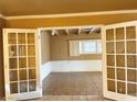 Bright living room with french doors and tile flooring at 1020 Wengert Ave, Las Vegas, NV 89104