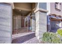Inviting gated front entrance with decorative brickwork and lush landscaping at 11242 Almador Vista Ct, Las Vegas, NV 89135