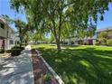 Scenic community featuring expansive green spaces with mature trees and manicured lawns at 173 Greenbriar Townhouse Way, Las Vegas, NV 89121
