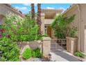 Charming entryway with a gated courtyard, lush landscaping, and a welcoming front door, enhancing curb appeal at 1848 Indian Bend Dr, Henderson, NV 89074