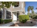 Charming front entrance with a white door, manicured landscaping, and desert surroundings at 1912 Summer Pine Ct # 103, Las Vegas, NV 89134