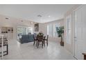 Open-concept living area with tile floors, lots of light, and dining area at 1912 Summer Pine Ct # 103, Las Vegas, NV 89134