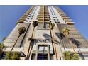 Modern high-rise building exterior featuring sleek architectural details and palm tree landscaping at 200 Hoover Ave # 912, Las Vegas, NV 89101