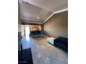 Open living area with tile floors, bar seating, and neutral walls at 210 E Flamingo Rd # 419, Las Vegas, NV 89169