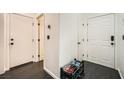 Entryway hallway with coat closet and shoe storage on dark floors at 2714 Cottonwillow St, Las Vegas, NV 89135
