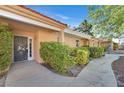 Charming front entrance showcasing a decorative door, well-maintained landscaping, and a covered walkway at 2851 S Valley View Blvd # 1026, Las Vegas, NV 89102