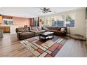 Spacious living room featuring a large sectional couch and wood laminate flooring at 334 Shimmering Moon St, Henderson, NV 89015