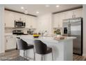 Modern kitchen features white cabinetry, stainless steel appliances, and a functional island at 376 Yellow Finch Ln, Henderson, NV 89012