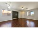 Spacious living room featuring hardwood floors, ample natural light, and modern lighting fixtures at 3961 Bayamon St, Las Vegas, NV 89129