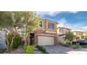 Charming two-story home featuring a stone facade, desert landscaping, and a brick paved driveway at 397 Purple Sandpiper St, Las Vegas, NV 89138