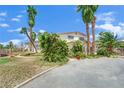 Two story home features mature landscaping and a circular driveway at 5890 W Patrick Ln, Las Vegas, NV 89118