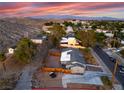 Expansive aerial view of a residential area showcasing mountain views and mature trees at 650 Arizona St, Boulder City, NV 89005