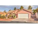 Charming single-story home with a desert landscape, barrel tile roof, and a two car garage at 7140 Pascal Dr, Las Vegas, NV 89156