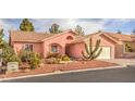 Charming single-story home with a desert landscape, barrel tile roof, and a two car garage at 7140 Pascal Dr, Las Vegas, NV 89156