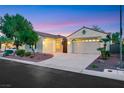 A charming single-story home showcasing a spacious driveway and a two-car garage at 7307 Lansbrook Ave, Las Vegas, NV 89131
