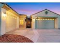 A three-car garage and ornate front door complement this beautiful home's exterior at 7307 Lansbrook Ave, Las Vegas, NV 89131