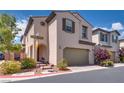 Two-story home featuring a two-car garage, neutral stucco, and low-maintenance landscaping at 7559 Chimney Point Ct, Las Vegas, NV 89166
