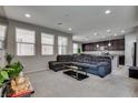Spacious living room with neutral walls and carpeting, large sectional, and plenty of natural light at 7559 Chimney Point Ct, Las Vegas, NV 89166