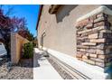Close up of the stucco and stone accent wall along the side of the home and walkway at 7609 Rory Ct, Las Vegas, NV 89129