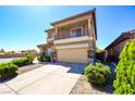 Stylish two-story home with a balcony, stucco facade, and a spacious two-car garage at 7609 Rory Ct, Las Vegas, NV 89129