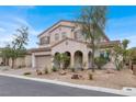Elegant home with a tile roof, arched entryway, desert landscaping, and a spacious two-car garage at 7878 Brianna Cheerful Ave, Las Vegas, NV 89178