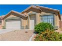 Inviting single-story residence showcasing desert landscaping, a two-car garage, and a cozy entrance at 7990 Timber Horn Ct, Las Vegas, NV 89147