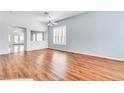 Bright living room with wood floors, fresh paint, shutters, and arched doorways for a welcoming ambiance at 7990 Timber Horn Ct, Las Vegas, NV 89147