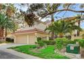 Charming home with red tile roof, well-manicured lawn, mature trees, and a spacious driveway that leads to a two-car garage at 8051 Castle Pines Ave, Las Vegas, NV 89113