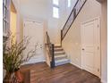 Inviting foyer with wood floors, a staircase with decorative railing, and plenty of natural light at 8171 California Pine St, Las Vegas, NV 89166