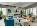 Inviting living room with a decorative fireplace and large windows at 8969 Rivers Edge Dr, Las Vegas, NV 89117