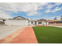 The home has a well-manicured front lawn, brick-paved driveway, and attached garage at 902 Westminster Ave, Las Vegas, NV 89119