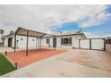 Charming home featuring a brick-paved yard with a covered area and white fence at 902 Westminster Ave, Las Vegas, NV 89119