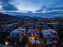 Stunning aerial view of a modern neighborhood at twilight, showcasing the community's layout and mountain backdrop at 10313 Jade Point Dr, Las Vegas, NV 89135