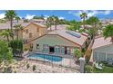 Aerial view of backyard with pool, patio, solar panels, and privacy fence at 1324 European Dr, Henderson, NV 89052