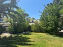 A lush front yard features mature trees, offering shade and enhancing the home's curb appeal at 1385 Ringe Ln, Las Vegas, NV 89110