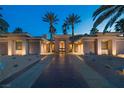 Beautiful desert home featuring a symmetrical facade, large windows, and a well-manicured yard at 1665 Liege Dr, Henderson, NV 89012