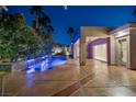 Sparkling pool area with a modern pool design, lush landscaping, and a covered patio at 1665 Liege Dr, Henderson, NV 89012
