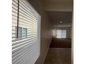 Well-lit and spacious living room with neutral paint and carpet, complemented by natural light at 3029 Frigate Way, North Las Vegas, NV 89084
