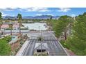 Gated entrance to a lakeside community features lush landscaping and a view of the water and mountains at 3080 Yankee Clipper Dr, Las Vegas, NV 89117