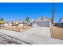 Street view of a single-story home showcasing a two-car garage and desert landscaping at 3118 Floral Vista Ave, Henderson, NV 89014