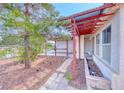 Exterior view highlighting a covered patio area with views of the well-maintained property at 3413 Freestone Ln, North Las Vegas, NV 89032