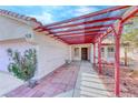 Inviting front entrance featuring a covered walkway and well-maintained landscaping around the front at 3413 Freestone Ln, North Las Vegas, NV 89032
