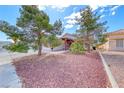 Charming property with rock landscaping and mature trees providing shade and curb appeal at 3413 Freestone Ln, North Las Vegas, NV 89032