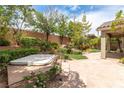 Private backyard features a patio, lush landscaping, and a relaxing spa at 3483 French Daisy St, Las Vegas, NV 89135