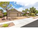 Charming one-story home with a three-car garage and desert landscaping at 3483 French Daisy St, Las Vegas, NV 89135
