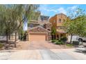 Charming two-story home with stone accents, a two-car garage, and landscaped front yard at 378 Gracious Way, Henderson, NV 89011