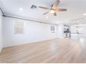Bright, open-concept living room featuring a ceiling fan and light wood flooring at 378 Gracious Way, Henderson, NV 89011