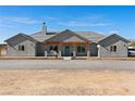 Charming single-story home with grey exterior, covered porch, and well-manicured gravel driveway at 3880 Rudek St, Pahrump, NV 89061