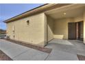 Covered entryway featuring a security door and desert landscaping at 4017 Gliding Gulls Ave, North Las Vegas, NV 89084