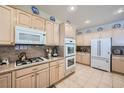 Bright kitchen with updated appliances, granite countertops, and abundant cabinetry for storage at 4187 Pacifico Ln, Las Vegas, NV 89135